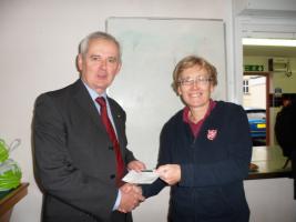 President Chris Bushell handing cheque to Major Alison from the Salvation Army